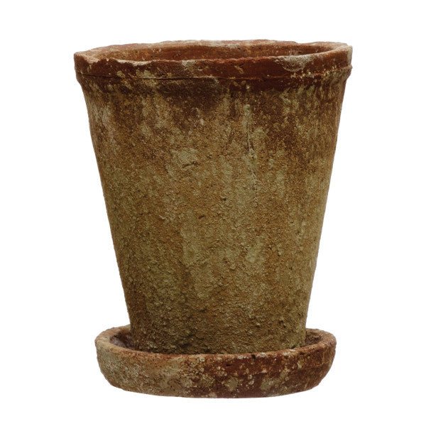 A round terracotta cement planter with a distressed finish and a saucer.